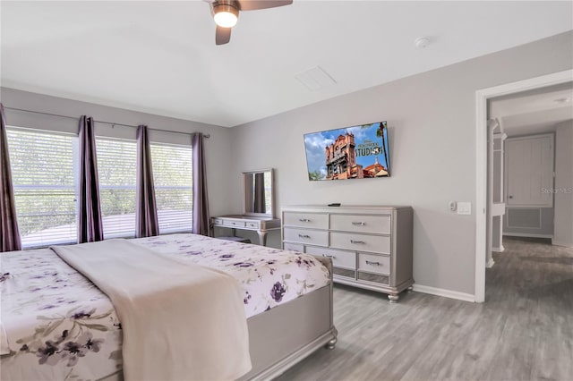 bedroom with light hardwood / wood-style floors and ceiling fan