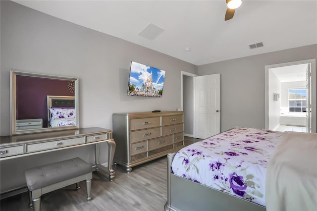 bedroom with connected bathroom, wood-type flooring, and ceiling fan