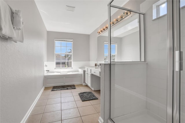 bathroom with independent shower and bath, vanity, and tile patterned floors