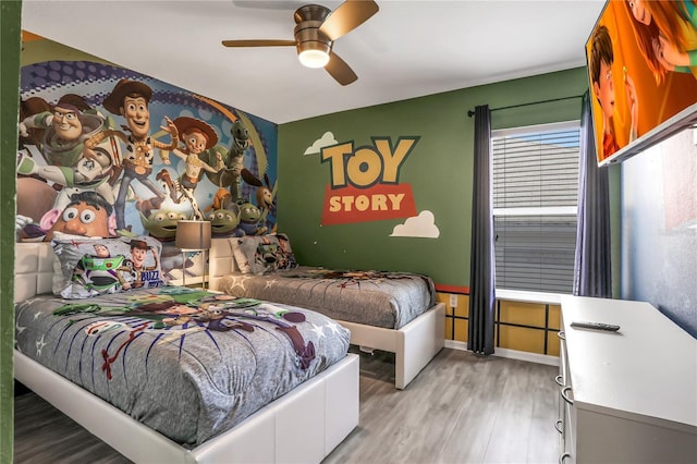 bedroom with ceiling fan and light hardwood / wood-style flooring