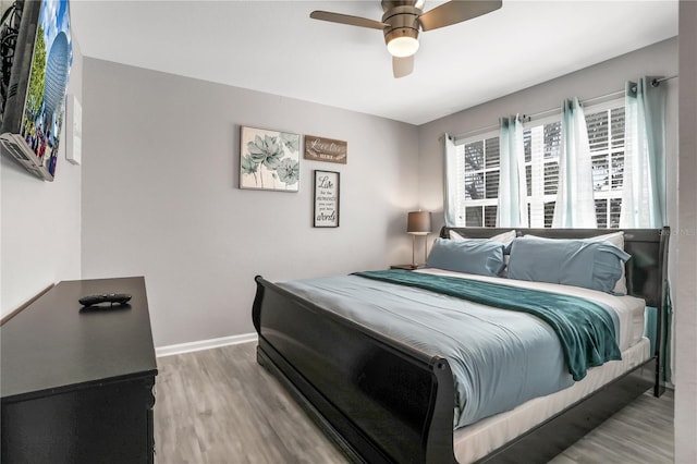 bedroom featuring hardwood / wood-style floors and ceiling fan