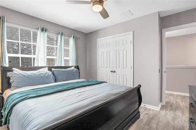 bedroom with ceiling fan, a closet, and light wood-type flooring