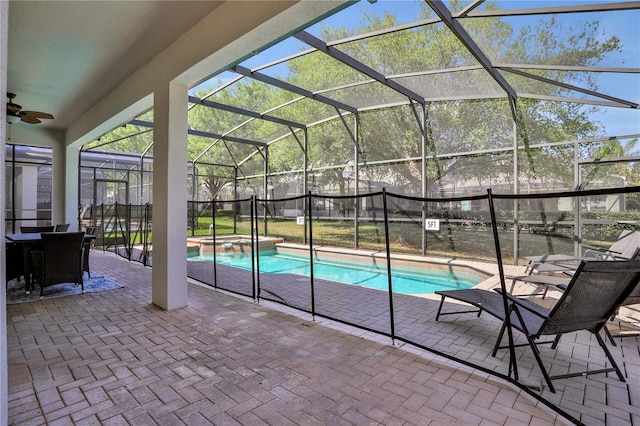 view of swimming pool featuring an in ground hot tub, a lanai, and a patio area