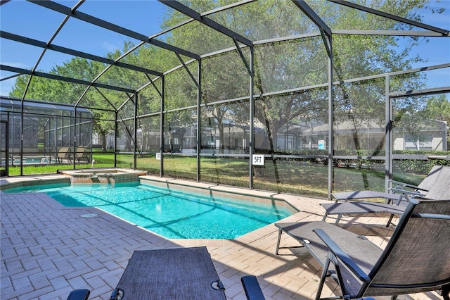 view of swimming pool featuring an in ground hot tub, a lanai, and a patio area