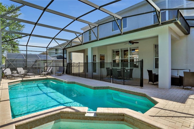 view of pool with a lanai, ceiling fan, and a patio area