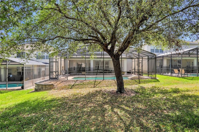 view of yard with glass enclosure