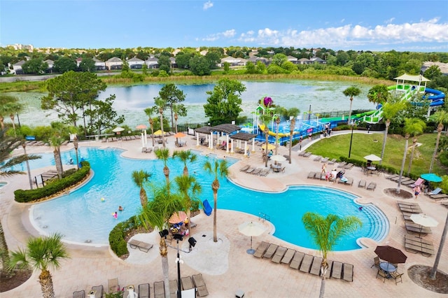 view of swimming pool with a water view and a patio area