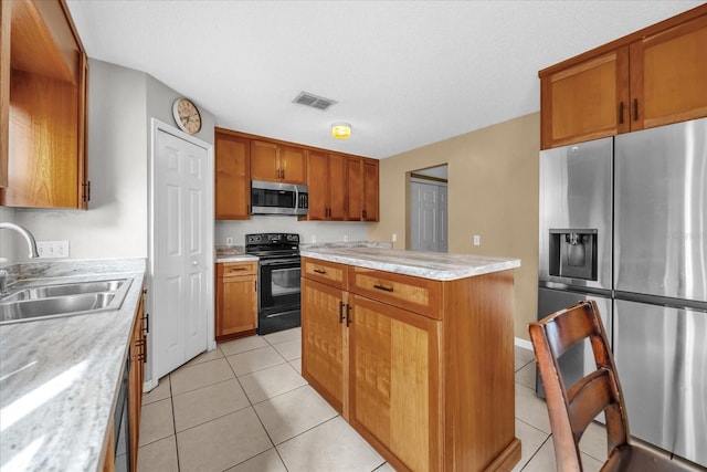 kitchen featuring light tile patterned flooring, sink, light stone counters, stainless steel appliances, and a textured ceiling