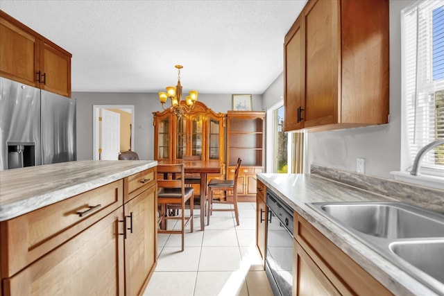 kitchen with light tile patterned flooring, pendant lighting, black dishwasher, sink, and plenty of natural light