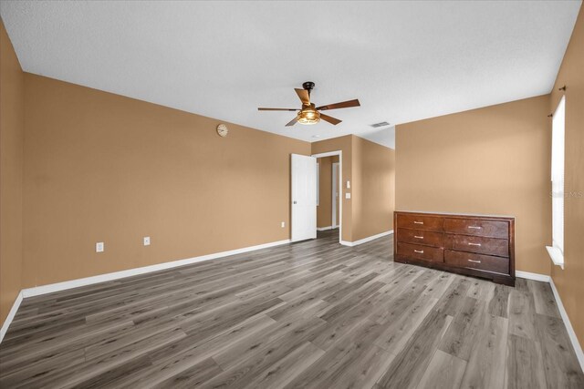 unfurnished room with ceiling fan and light wood-type flooring