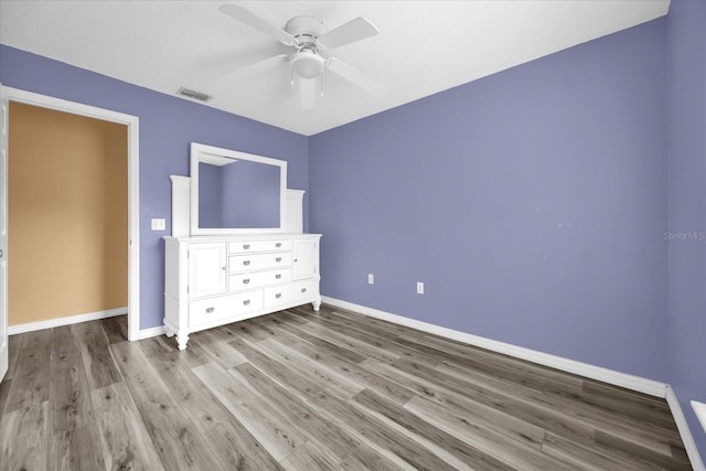 unfurnished bedroom featuring ceiling fan and wood-type flooring