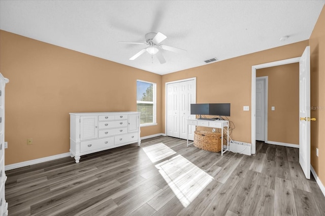 interior space with hardwood / wood-style flooring, a closet, and ceiling fan