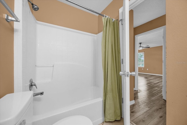 bathroom featuring toilet, hardwood / wood-style floors, and shower / bath combo with shower curtain