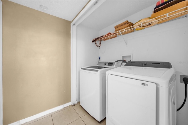 washroom featuring washer and dryer and light tile patterned floors