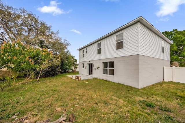 rear view of property with a patio area and a lawn