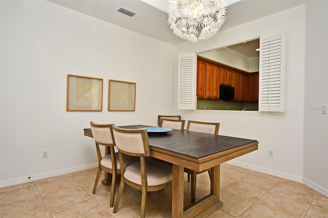 8766 The Esplanade Unit 23, Orlando, FL 32836 - dining area with baseboards, visible vents, an inviting chandelier, and light tile patterned floors