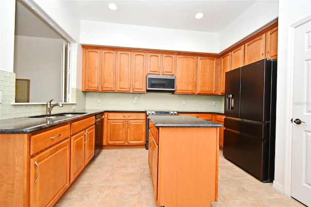 8766 The Esplanade Unit 23, Orlando, FL 32836 - kitchen featuring a kitchen island, stainless steel appliances, dark stone countertops, and decorative backsplash