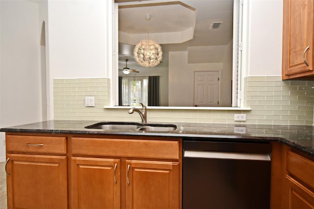 8766 The Esplanade Unit 23, Orlando, FL 32836 - kitchen featuring a sink, tasteful backsplash, dishwashing machine, dark stone countertops, and visible vents