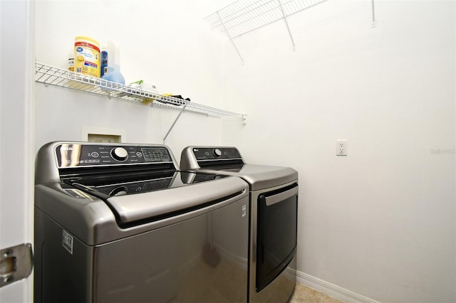 8766 The Esplanade Unit 23, Orlando, FL 32836 - laundry room featuring baseboards, washing machine and dryer, and laundry area