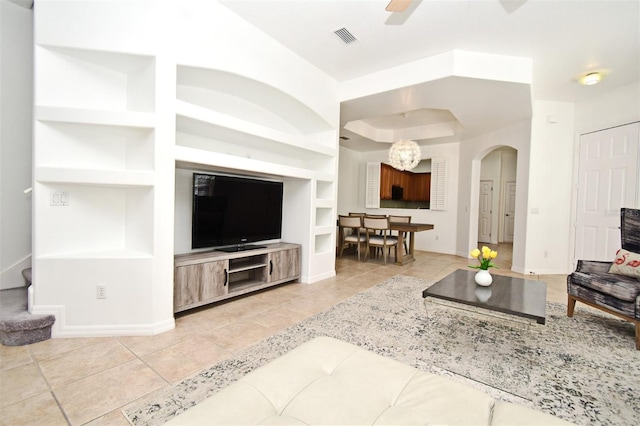 8766 The Esplanade Unit 23, Orlando, FL 32836 - living area with light tile patterned floors, visible vents, arched walkways, and built in shelves