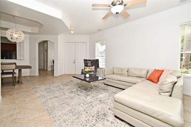 8766 The Esplanade Unit 23, Orlando, FL 32836 - living area featuring visible vents, baseboards, arched walkways, ceiling fan with notable chandelier, and light tile patterned floors