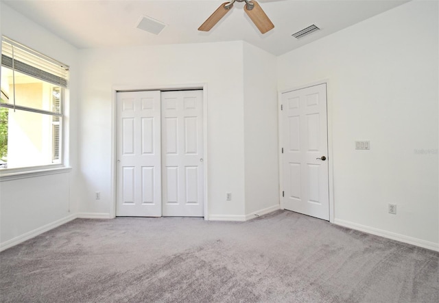 8766 The Esplanade Unit 23, Orlando, FL 32836 - unfurnished bedroom with baseboards, visible vents, a closet, and carpet flooring