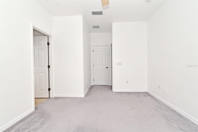 8766 The Esplanade Unit 23, Orlando, FL 32836 - unfurnished bedroom with light carpet, baseboards, and visible vents