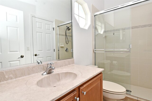 8766 The Esplanade Unit 23, Orlando, FL 32836 - bathroom featuring a stall shower, toilet, and vanity
