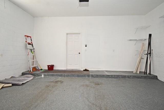 8766 The Esplanade Unit 23, Orlando, FL 32836 - garage with concrete block wall and a garage door opener