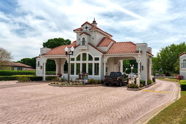 8766 The Esplanade Unit 23, Orlando, FL 32836 - exterior space with stucco siding, a chimney, a tiled roof, and decorative driveway