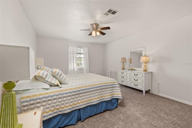 bedroom with baseboards, visible vents, a ceiling fan, a textured ceiling, and carpet flooring