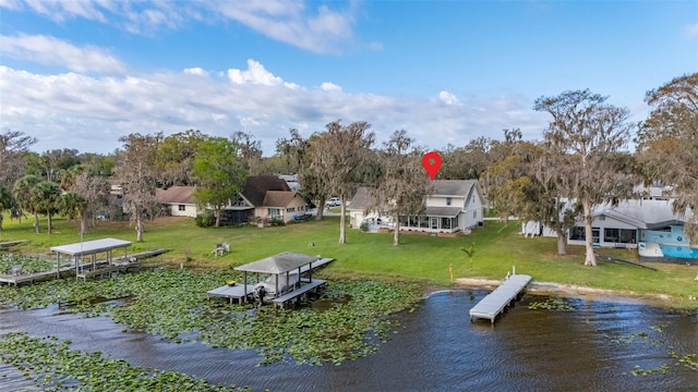 dock area featuring a water view, a residential view, and a yard