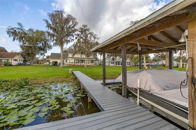 dock area with a residential view and a lawn