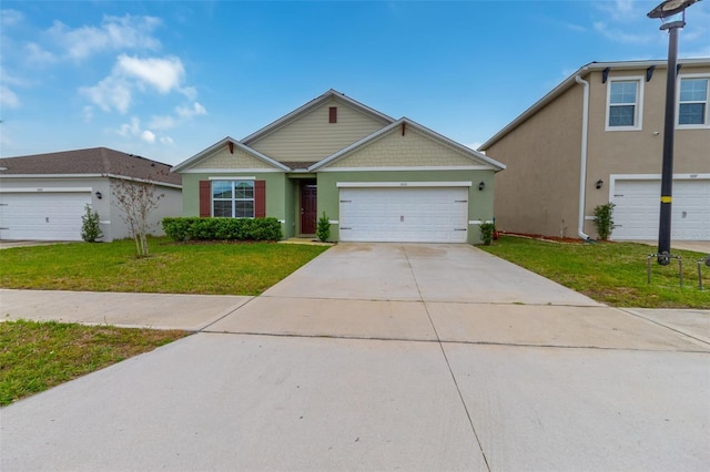 view of front of home with a front yard and a garage