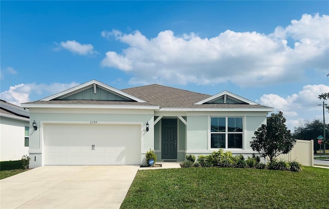 view of front facade featuring a front lawn and a garage