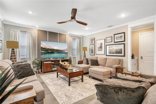 living room featuring ceiling fan and crown molding