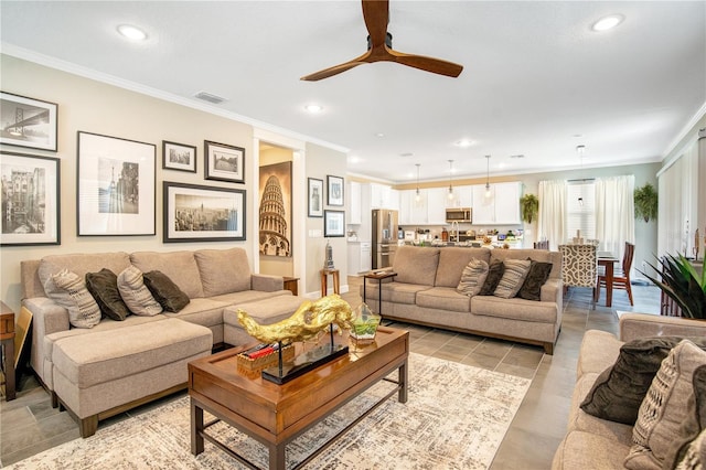 living room with ceiling fan, ornamental molding, and light tile patterned floors