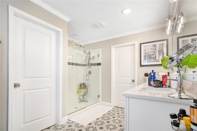 bathroom featuring ornamental molding, vanity, and a shower with shower door