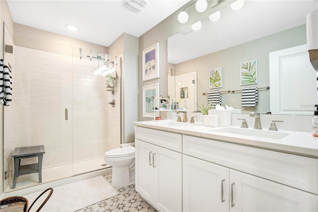 bathroom with an enclosed shower, vanity, and toilet