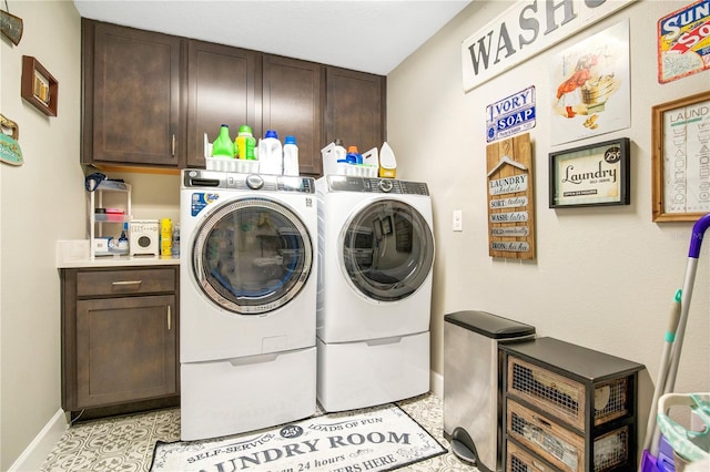 laundry area with light tile patterned floors, separate washer and dryer, and cabinets