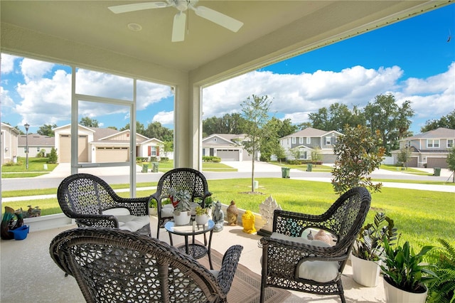 sunroom / solarium featuring ceiling fan