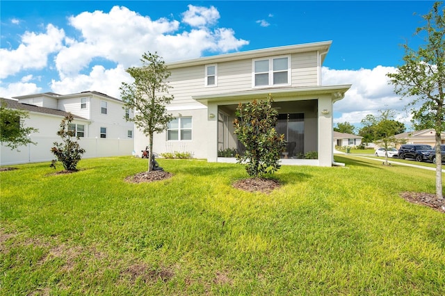 rear view of property with a lawn