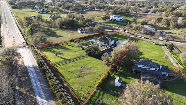 birds eye view of property with a rural view