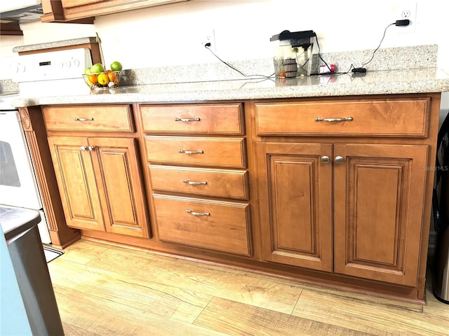 kitchen with electric range and light stone counters