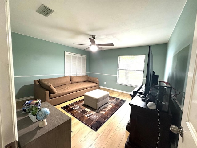 living room with ceiling fan and wood-type flooring