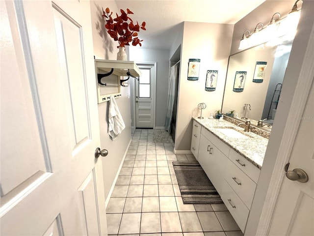 bathroom featuring tile patterned floors, a textured ceiling, curtained shower, and vanity