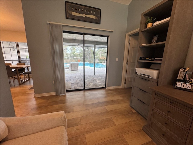 doorway with built in features and light hardwood / wood-style flooring