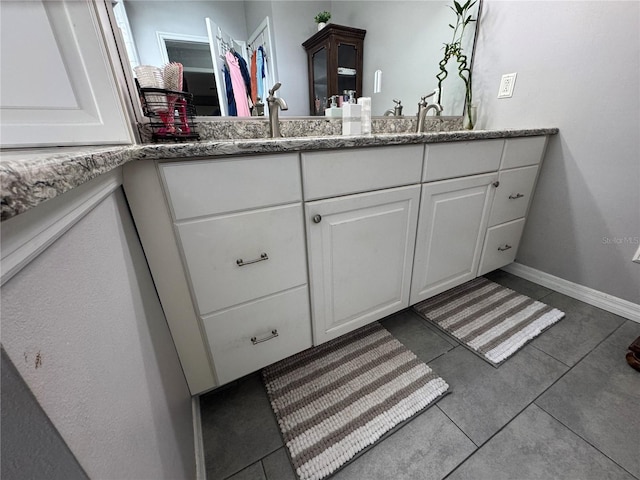 bathroom with vanity and tile patterned flooring