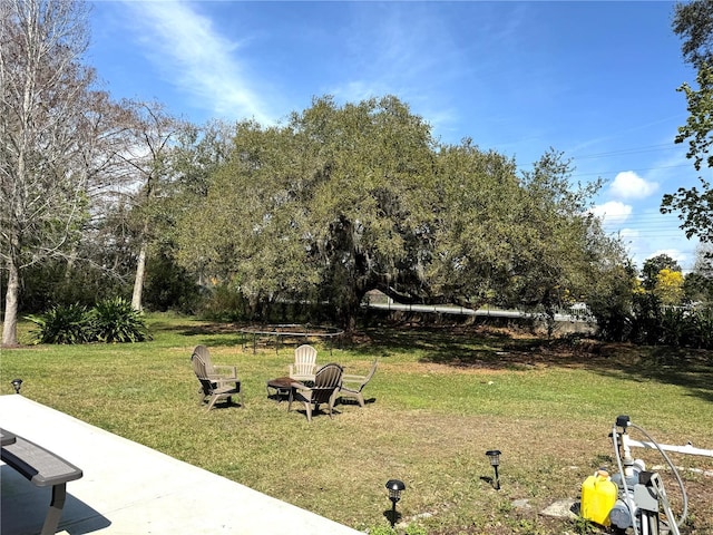 view of yard featuring an outdoor fire pit