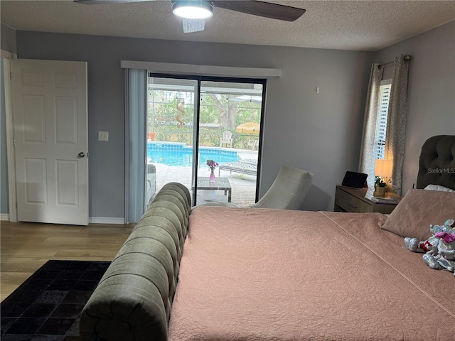 bedroom featuring ceiling fan, wood-type flooring, access to exterior, and a textured ceiling